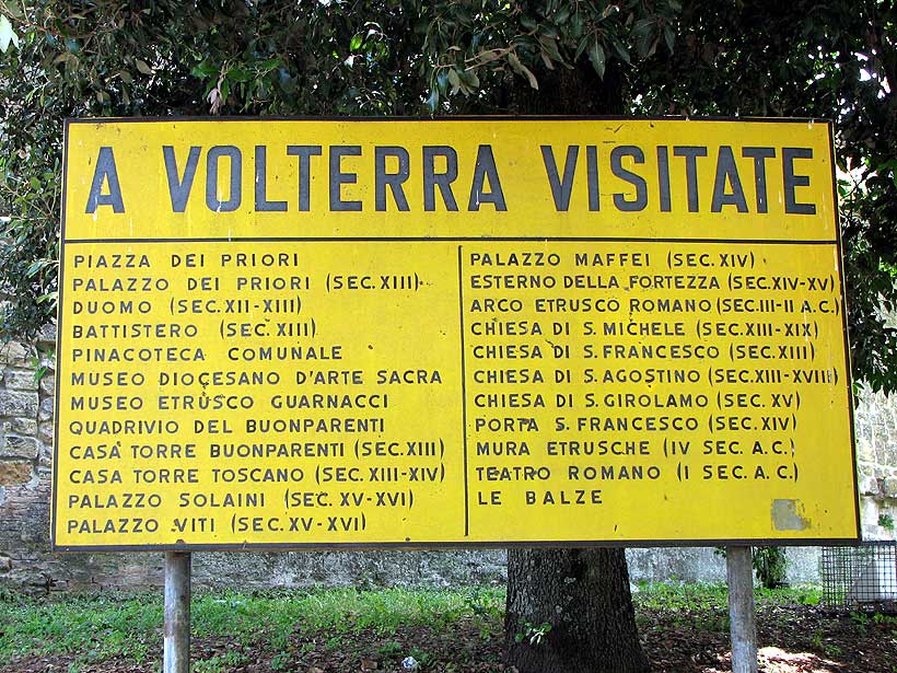 Sign near the entrance gate to the town of Volterra, Italy